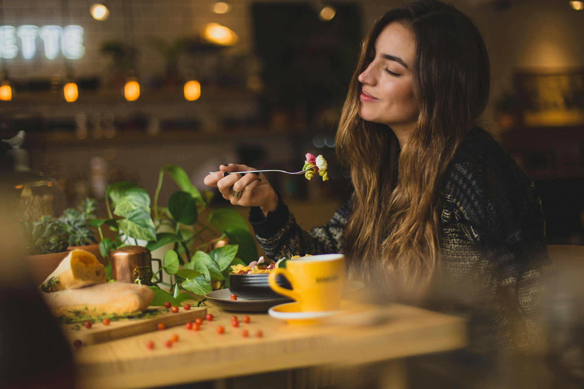 woman-holding-fork-in-front-table.jpg woman holding fork in front table