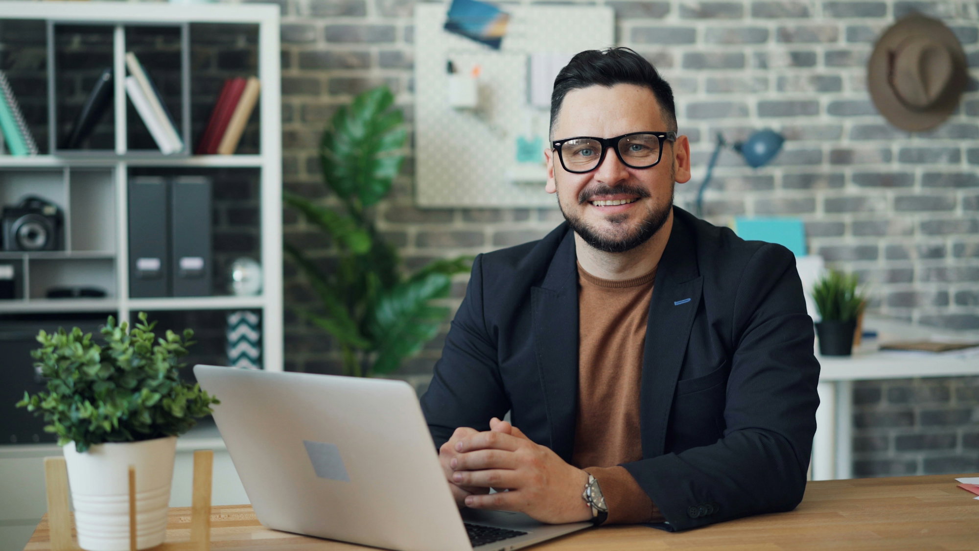 a-man-sitting-at-a-table-with-a-laptop.jpg a man sitting at a table with a laptop